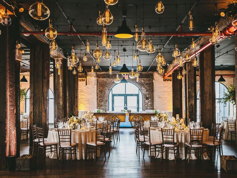 indoor wedding reception venue with edison bulbs in different sizes hanging from the ceiling