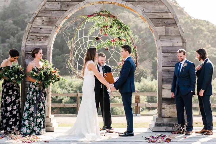 Bohemian Ceremony Setup with Wood Arch and Dream Catcher Backdrop