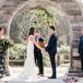Bohemian Ceremony Setup with Wood Arch and Dream Catcher Backdrop