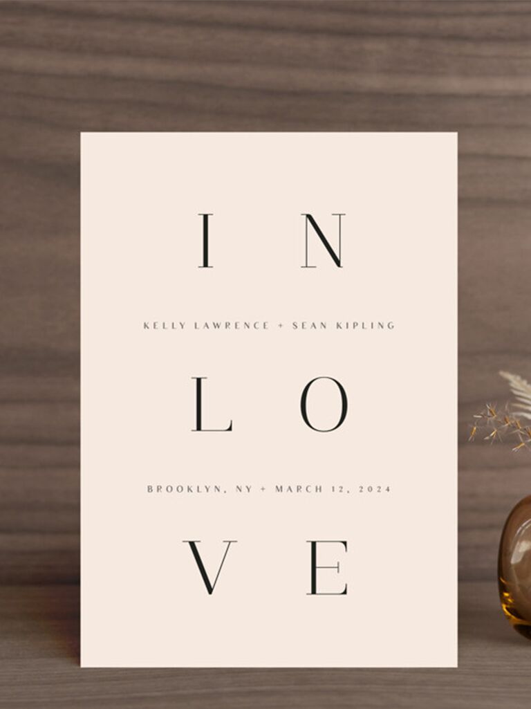 'In love' spelled out in three lines in minimal type on cream background