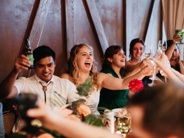 Bride and groom reaction to bridesmaid speech during wedding reception