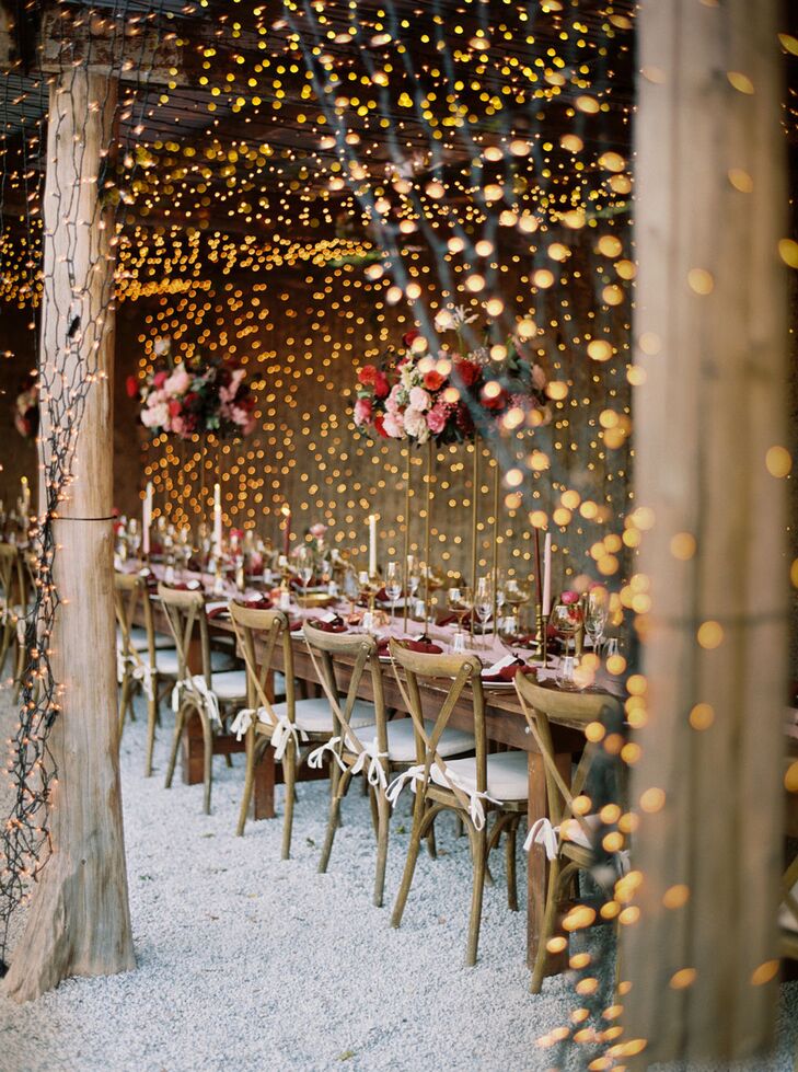 Magical String Lights Around and Overhead Long Table With Pink Flowers