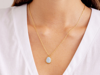 Light blue raw-cut gemstone on gold chain