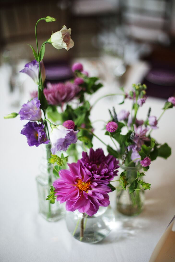 Centerpieces at the reception were simple, with various arrangements of purple chrysanthemums, dahlias and wildflowers in small glass vases.