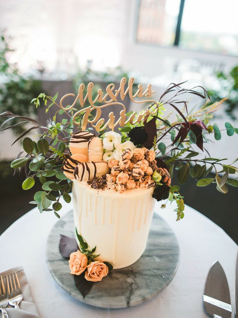 one tier wedding cake with chocolate pieces, cookies and popcorn on top
