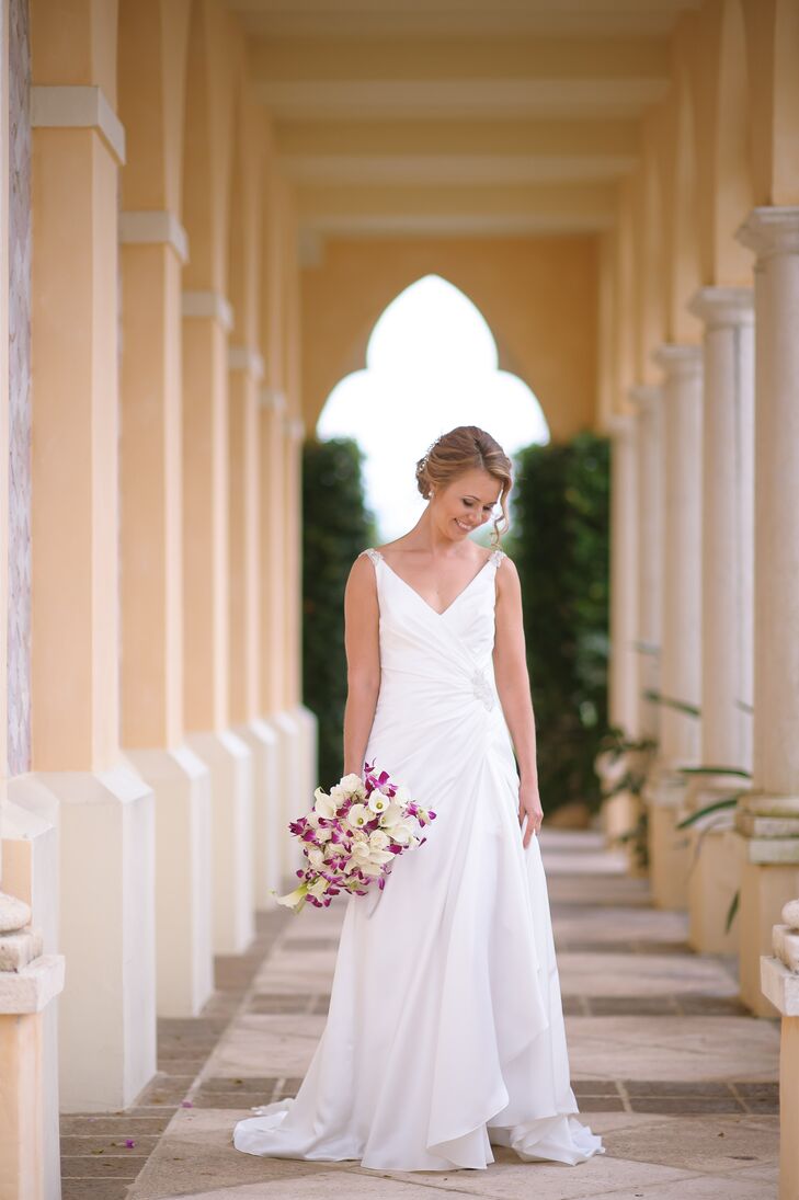 The team at Red Carpet Boutique in New Jersey helped Irina find a classic white wedding dress with a low back and simple ruche detailing at the waist.  The dress also had one fun twist. "It even had a high slit that you could see only if I swung it a certain way or put my leg out,” Irina says. To complement the look, Dalsimer Atlas designed a calla lily and orchid cascading bouquet for her.