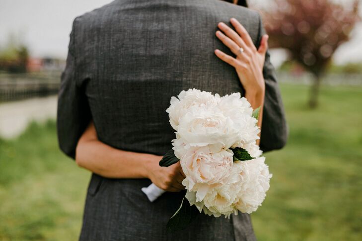 “We love the outdoors and being in the woods, so I wanted a natural and simple feel for the floral design,” Janel says. For her bridal bouquet, she worked with Cory Davenport to design a classic white and blush arrangement. Her favorite full peonies overflowed from its classic white ribbon wrap. Meticulously placed leaves added texture to the display.