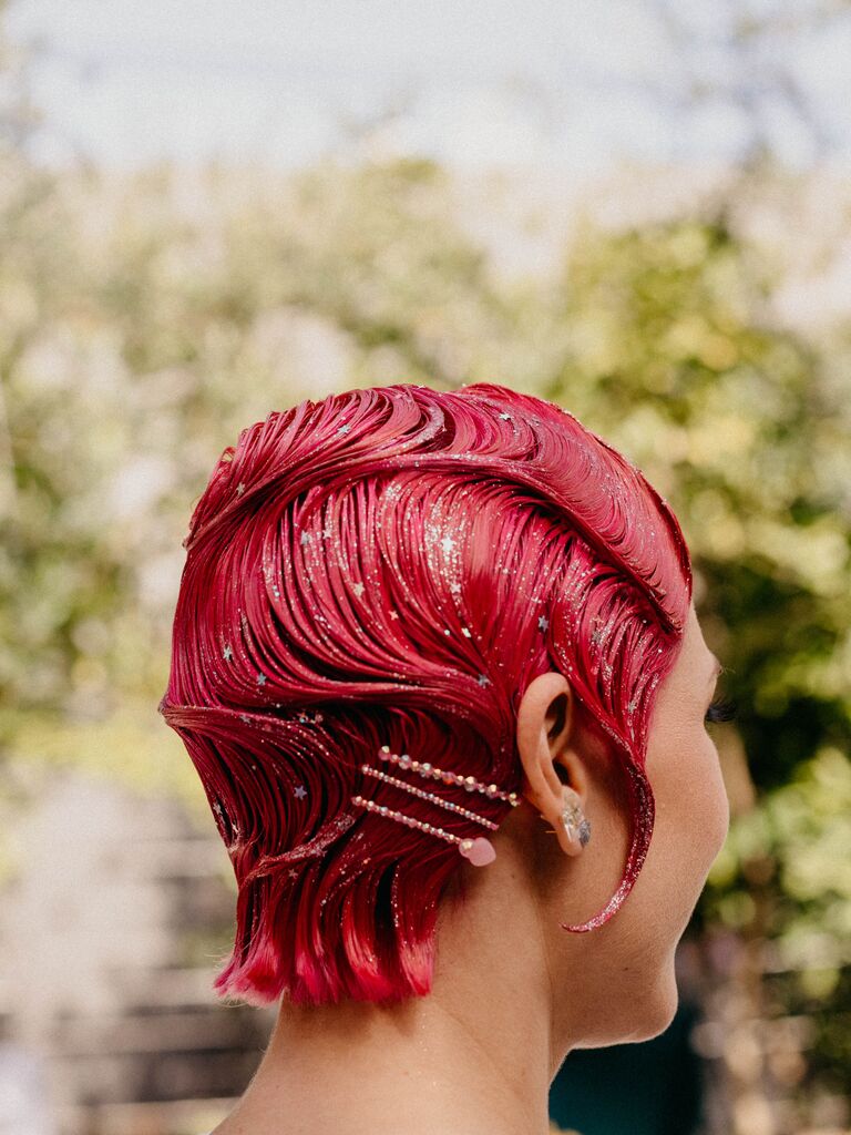 bride with magenta pink pixie haircut styled in marcel waves with glitter and bobby pins