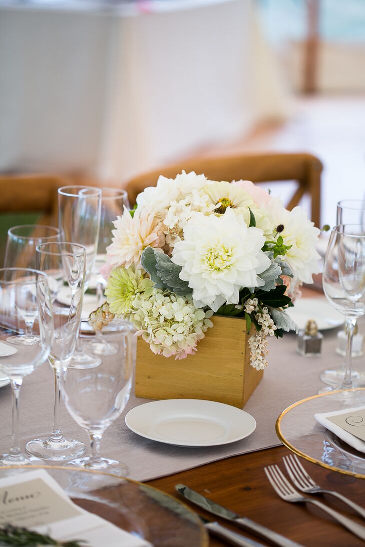The couple’s florist from Beautiful Days designed eye-catching tablescapes for the reception with gold lanterns alongside low floral centerpieces in gold breakaway vases. Each was filled with a romantic display of white hydrangea, white and blush dahlias, pink roses, green gerber daisies, pink garden roses and dusty miller.