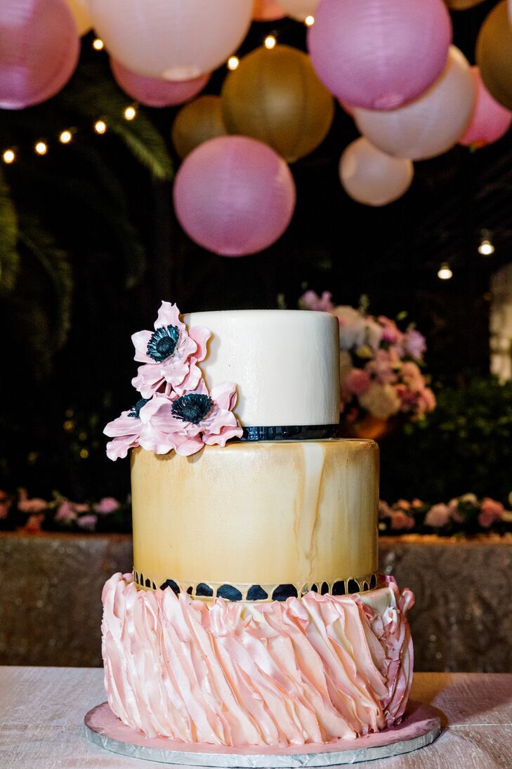 Lona and Bryan enjoyed a three-tier fondant cake with a pale pink leaf-textured bottom layer, an antique gold middle layer and an ivory top layer with pink anemone sugar flowers. The couple also had an extra sheet cake to be sure they had enough for everyone.