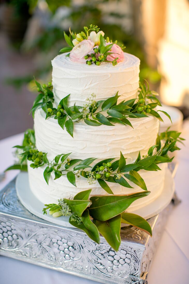 The Gage Hotel baked Jesse and Desha's classic triple-tier white wedding cake. The couple chose to surround the tiers in greenery for a natural, earthy look.