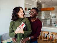 Man presenting gift to his partner