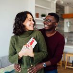 Man presenting gift to his partner