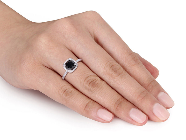 Cushion cut black diamond center with pave diamond square halo on thin white gold band with pave diamonds