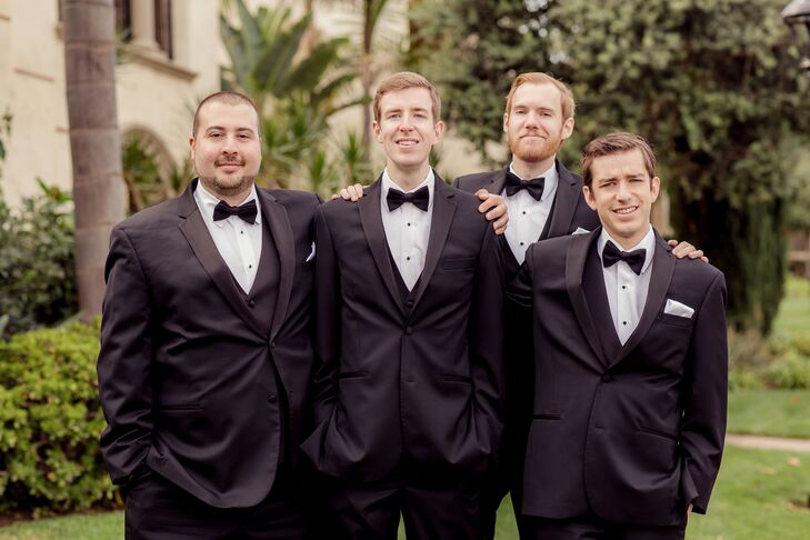 David and his groomsmen each wore a sharp, black tuxedo with a white shirt and black bow tie. Each groomsmen wore a boutonniere of a single ivory rose and carried an engraved pocket watch that the groom had ordered from Etsy as a gift.