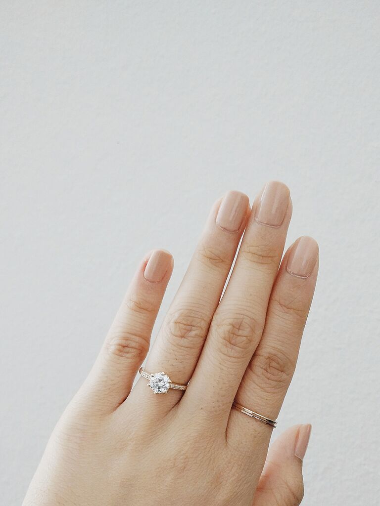 Simple engagement ring selfie idea with a plain background