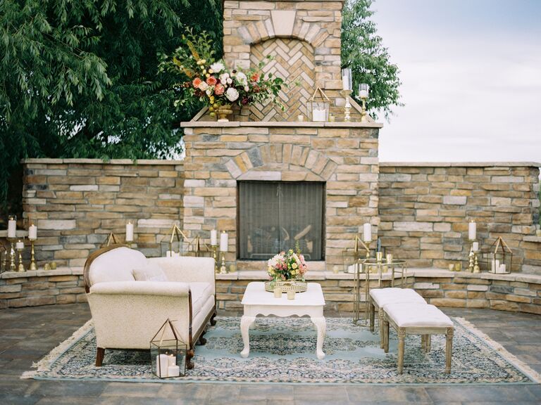 outdoor wedding lounge area with brick fireplace in the background