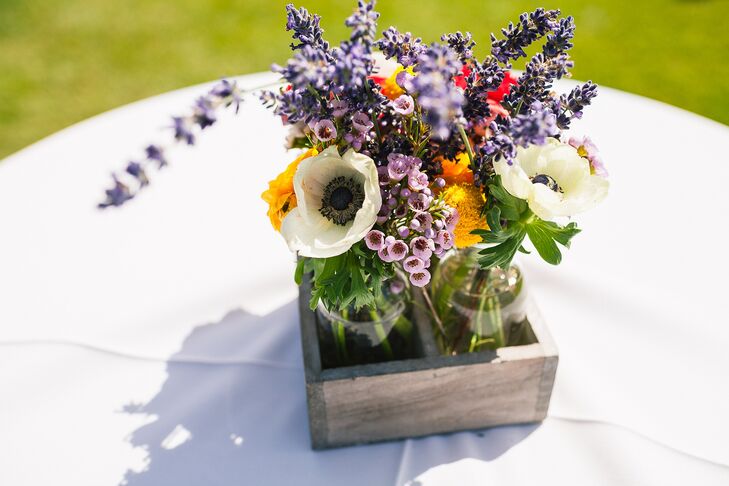 Lush flower arrangements of ivory anemones and lavender were arranged inside a rustic wood box and served as a table centerpiece.