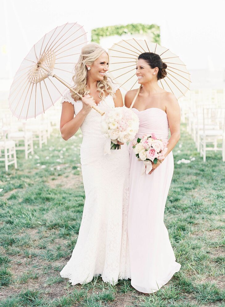Bridesmaids donned strapless floor-length Donna Morgan dresses in “petal” pink and carried an ivory and pink bouquet of roses, dahlias and hydrangeas.