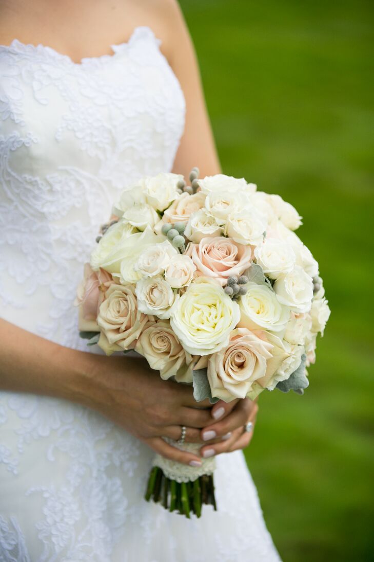 Forever in Bloom florist created this lush ivory and blush-colored bouquet for the bride using hypericum berries and roses.