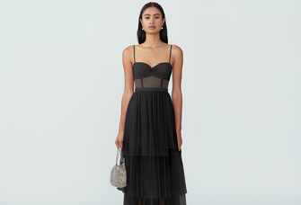 Floor length dress with tiered skirt and corset top