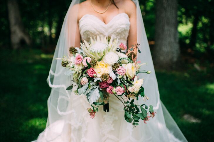 Kim’s bouquet resembled a garden in itself. Pink and fuchsia roses, dusty miller, scabiosa, seeded eucalyptus and white ranunculus all cascaded down the arrangement. Ibranyi Is Floral marked the top with a grand white king protea, yellow roses, yellow astilbes and orange gloriosa lilies. Even seeded eucalyptus and white veronica popped from the arrangement. But what made it especially personal was the wrap. “I had three of my grandmother's brooches attached to the stems. Wrapped around that was my godmother’s wedding handkerchief. I call her 'fairy godmother,' ” Kim says.