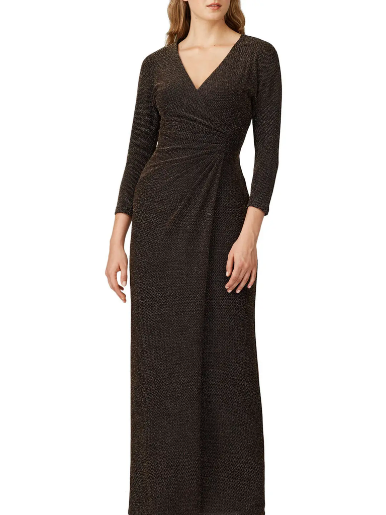 A model wears this V-neck wrap dress in shimmery black.