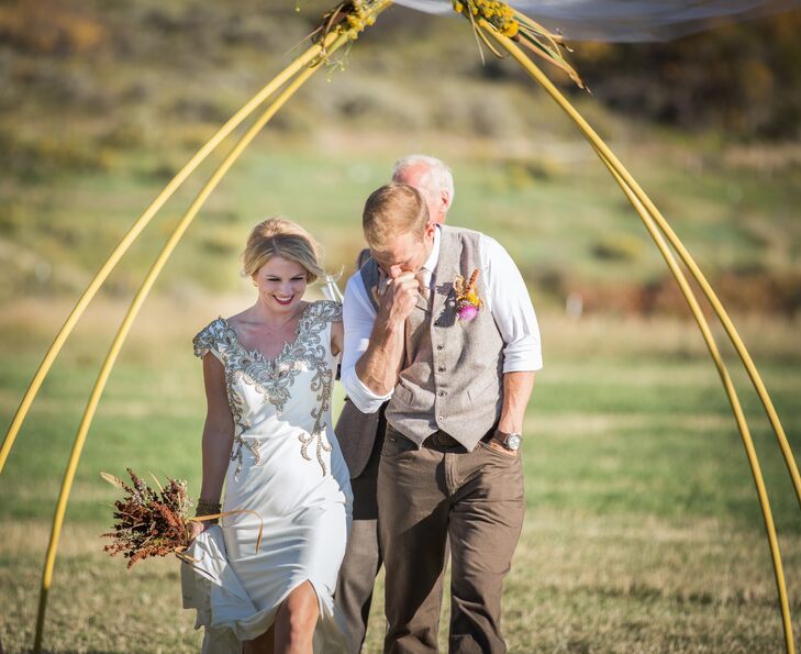 Wanting the naturally stunning vistas to do most of the work for their Meeker, Colorado wedding, Kelsey and Joey kept their decor minimal. They exchanged vows under a yellow arch that was decorated with yellow wildflowers and white drapery that blew in the wind.