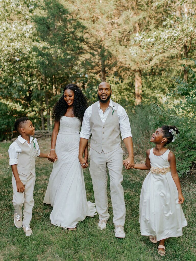 bride and groom walking with ring bearer and flower girl