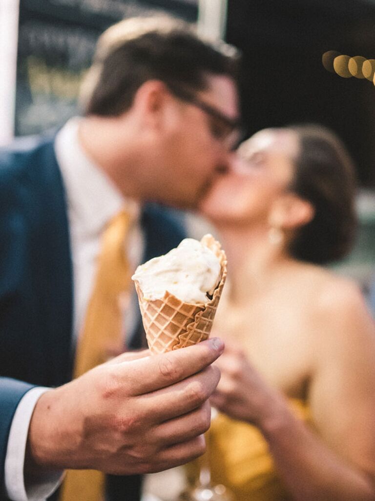 Bride and groom eating ice cream during summer wedding reception