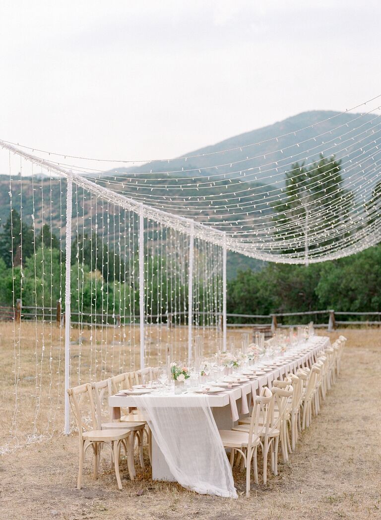 Long reception table under canopy of twinkle lights
