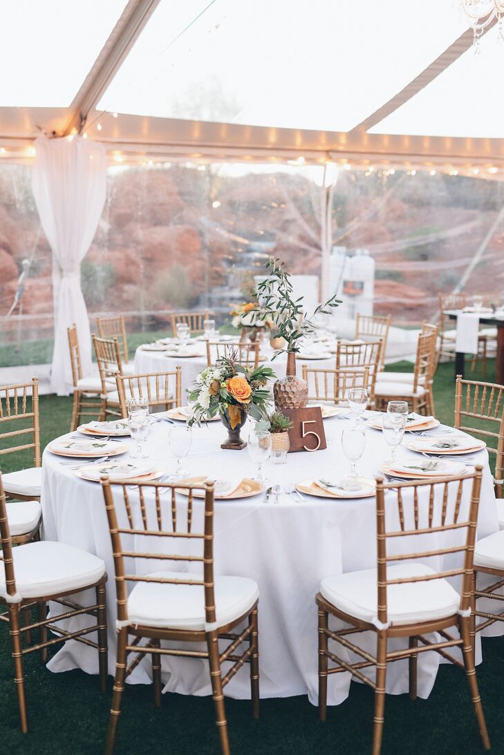 The color scheme included slate grey and navy as well as dark woods. Contrast and color was added with metallics and greenery. The couple's wedding planner had access to their Pinterest board, with creative liberty to make the most of the decor.