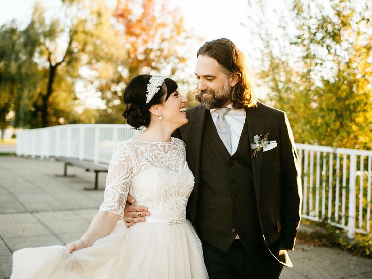 Groom with bride wearing vintage lace and tulle wedding dress