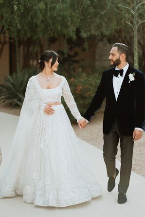 Bride in Lehenga Holding Hands With Groom in Tux