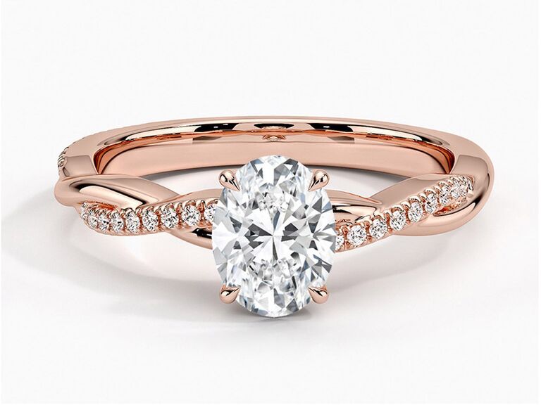 brilliant earth rose gold engagement ring with oval center stone claw prongs and round diamond and plain rose gold twisted band