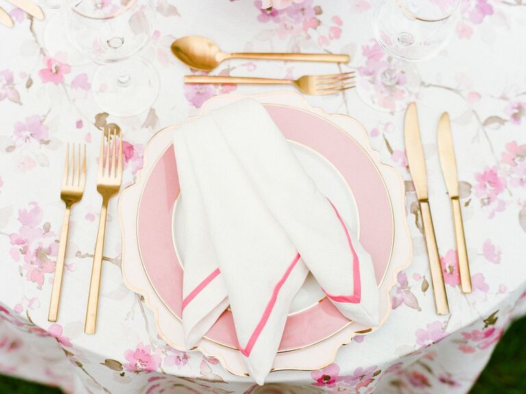 Pink-and-gold place setting with patterned linens