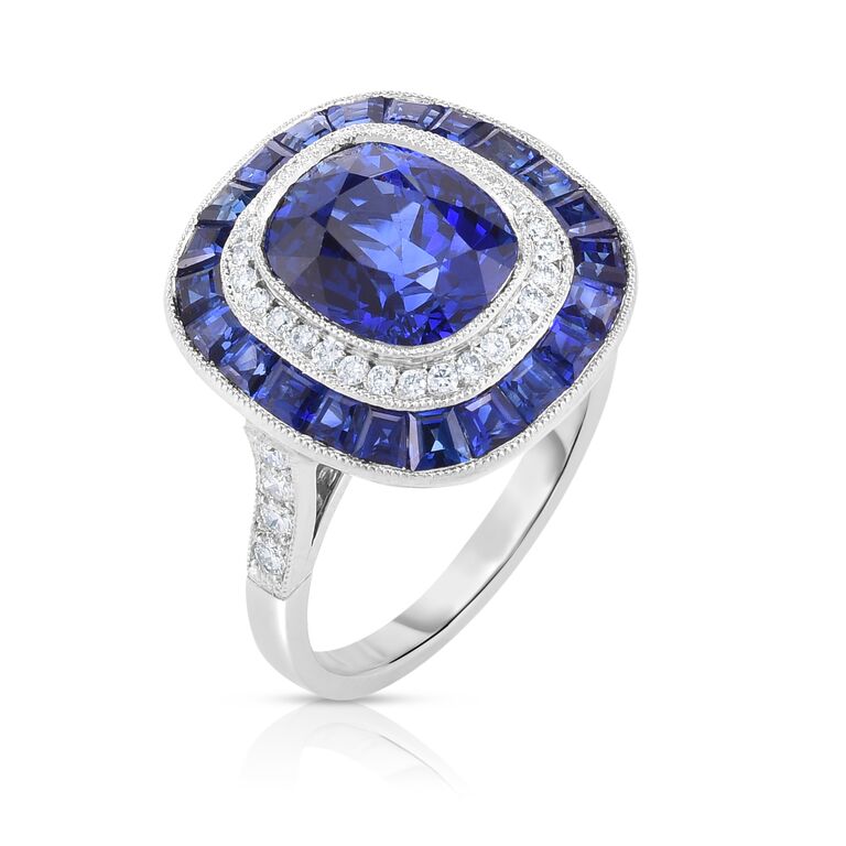 A silver ring with one circle of sapphires, another of diamonds, and a central sapphire.