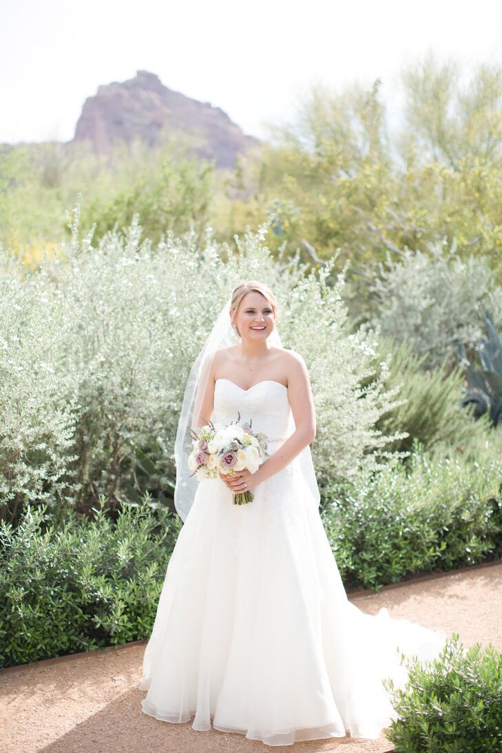 From the get-go, Kathleen was convinced that she wanted to walk down the aisle in a lacy fit-and-flare gown, but after visiting two different bridal salons and trying countless gowns she still hadn’t found one that brought the wow-factor she was after. “Then one of the associates at the second bridal shop had me try on an A-line dress,” says Kathleen. “I instantly fell in love. It was classic and simple, yet had the perfect amount of detail in lace and fabric.” She paired the look with an elegant pair of drop earrings, a crystal-embellished belt and a simple fingertip-length veil.