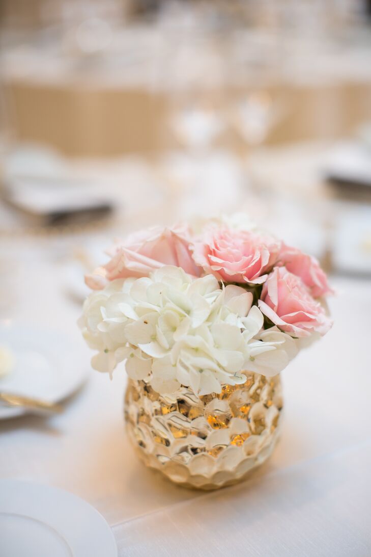 Neutral linens and metallic votives topped each round reception table along with Lucite candelabras, bejeweled globes and centerpieces that incorporated white hydrangeas and pink roses.