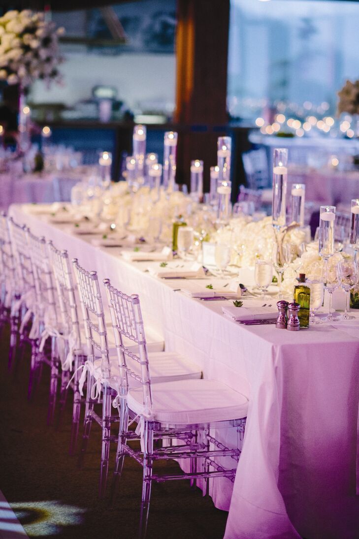 Contemporary clear reception chairs lined each table.