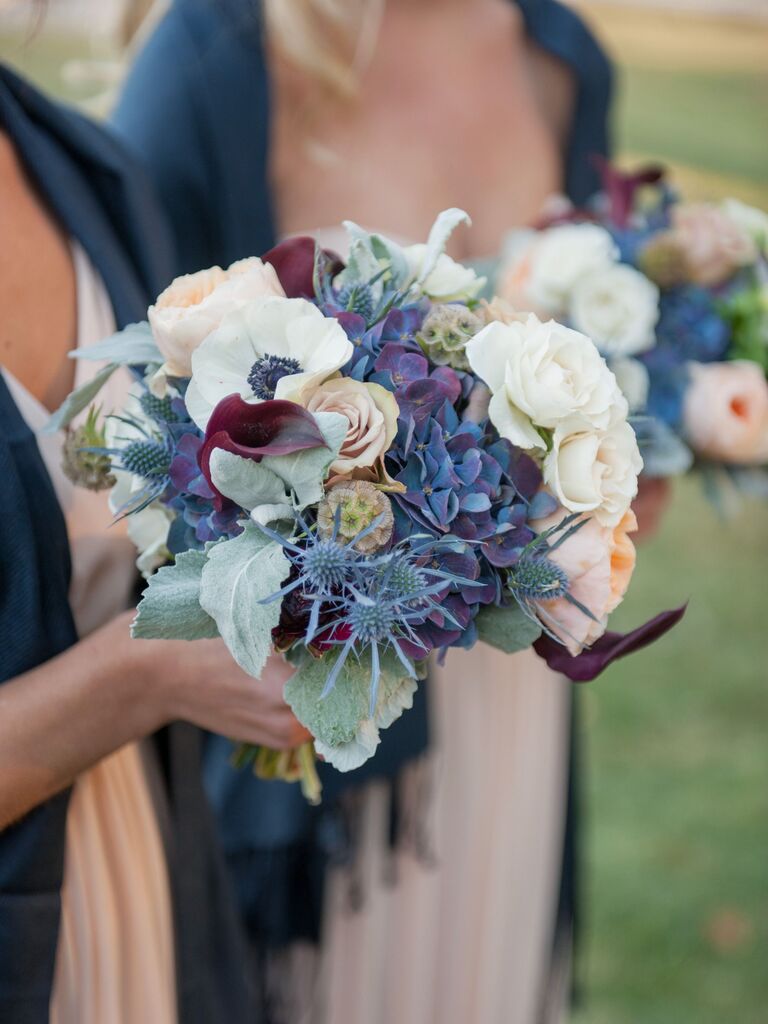 Bridesmaids hold wintery blue and white bouquets.