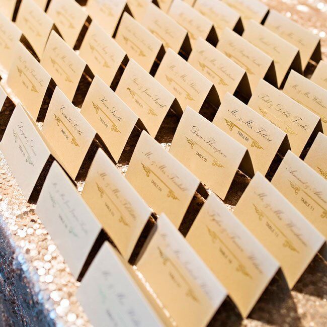 Guests found their seats with classic formal escort cards laid out on a sequin tablecloth.