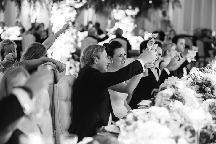 Guests all raised etched antique glasses to toast the newlyweds during the joyous celebration.