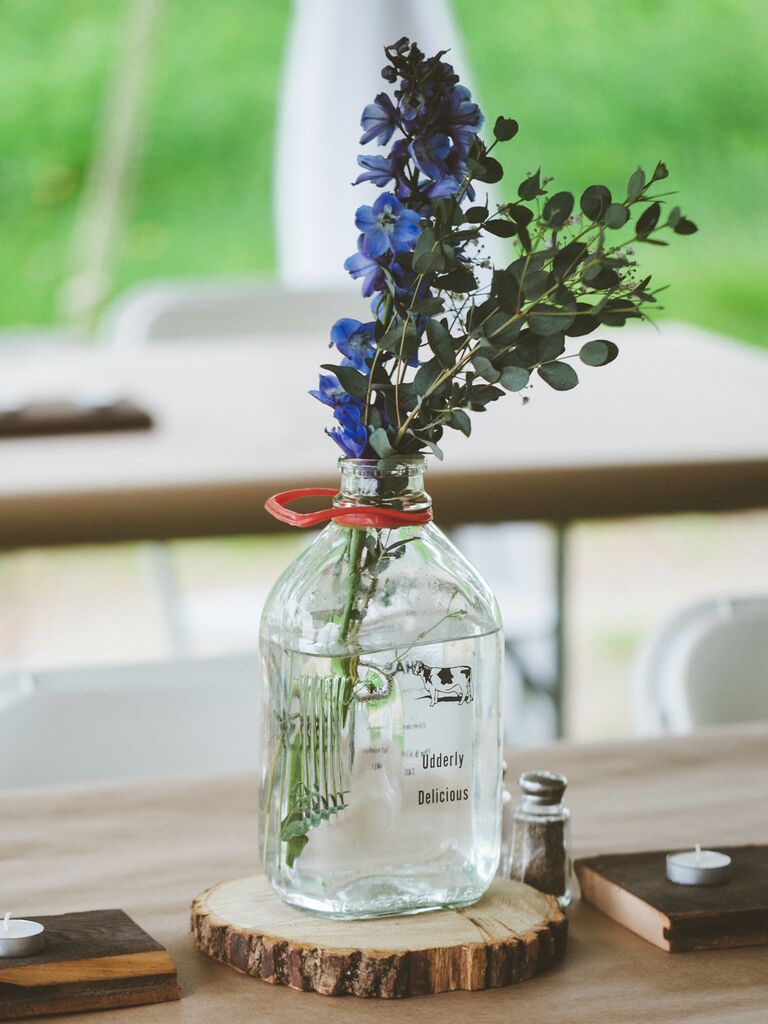 rustic red, white and blue wedding centerpiece with delphinium and glass milk jug