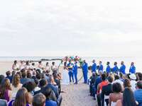 Beach wedding ceremony guests' attire