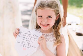 Smiling flower girl with custom handkerchief flower girl gift.