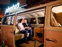 Couple kissing in vintage van photo booth