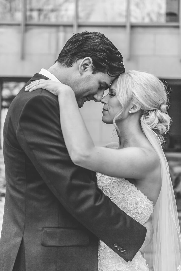 As Corinne and John shared an intimate moment,  Corinne's fingertip-length veil accented with scallop lace draped down her back. She pinned the elegant veil under her messy bun updo.