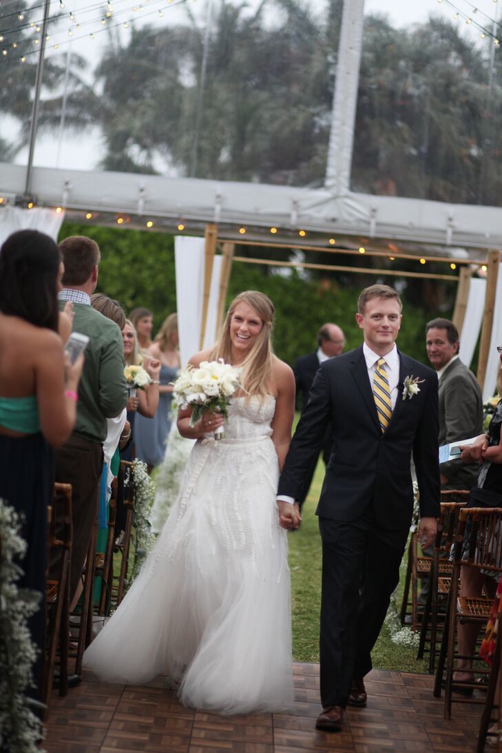 Jake and his groomsmen wore custom navy suits by Indochino with yellow Brooks Brother ties. Jake and Elle’s brother lined their suits with a matching American Flag print, says Elle.