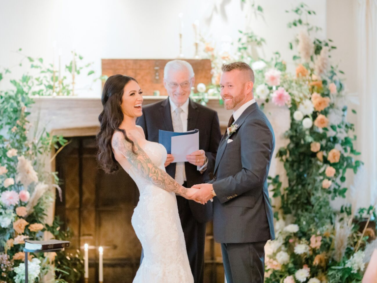 Bride and groom holding hands at the altar
